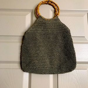 Vintage woven straw bag with round bamboo handles .